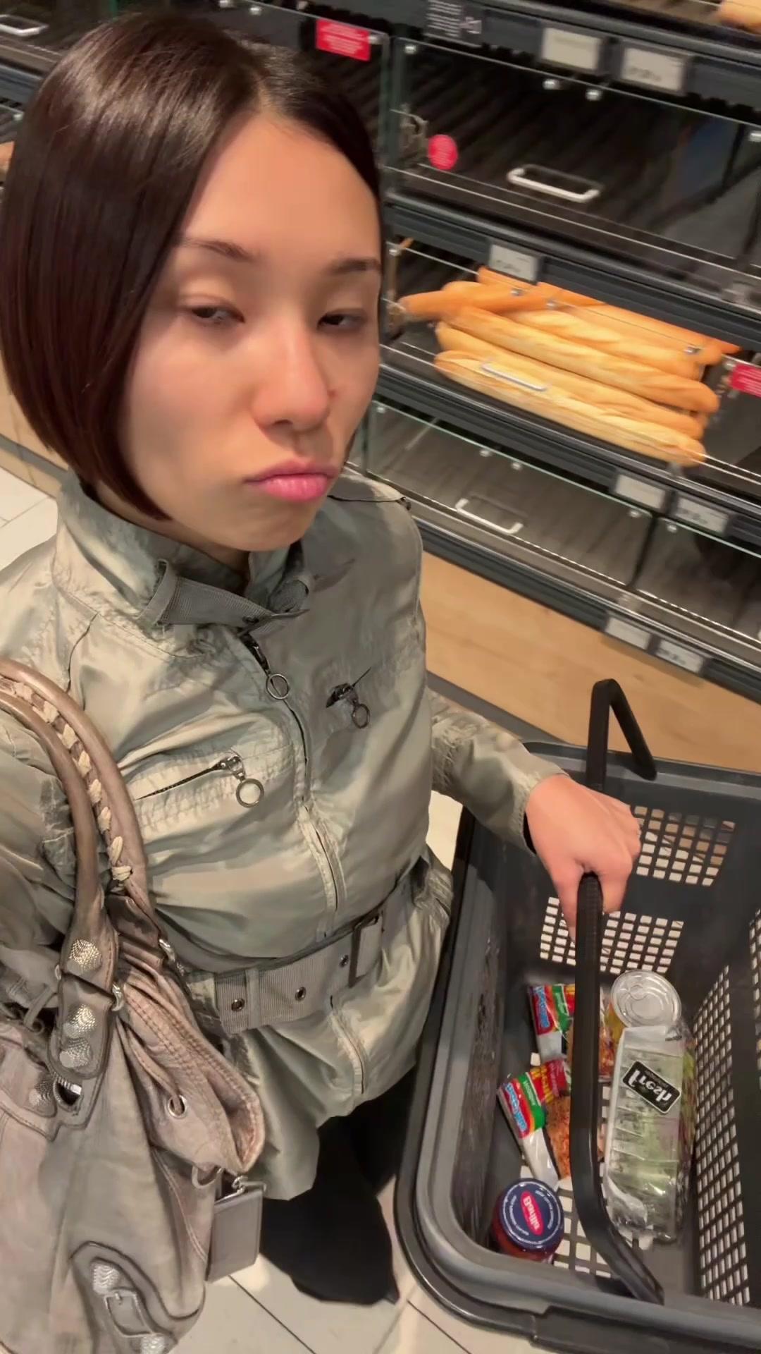 Woman Comparing Products in Supermarket
